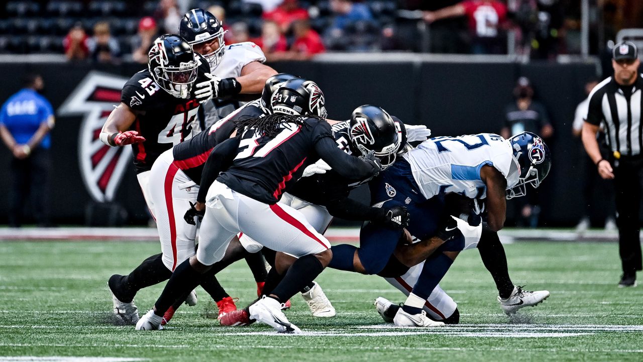 Tennessee Titans offensive guard Chandon Herring (68) fist bumps an Atlanta  police officer after a preseason NFL football game against the Atlanta  Falcons, Friday, Aug. 13, 2021, in Atlanta. The Tennessee Titans