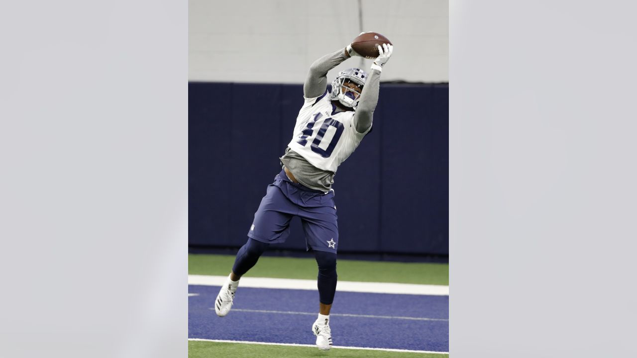 Dallas Cowboys defensive end Taco Charlton (97) watches the team work out  from the sideline at the team's NFL football training facility in Frisco,  Texas, Tuesday, June 11, 2019. (AP Photo/Tony Gutierrez