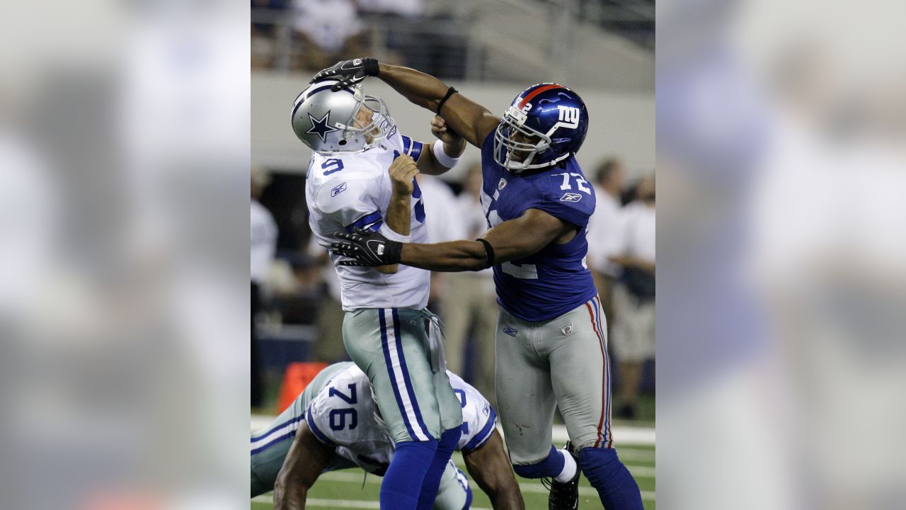 Dallas Cowboys Tony Romo gets pressured by New York Giants Michael Strahan  in the second half of their playoff game January 13, 2008 at Texas Stadium  in Irving, TX. The Giants beat