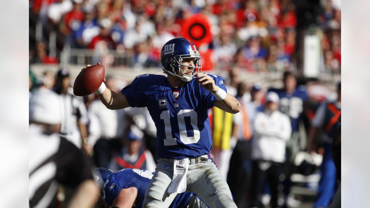 New York Giants quarterback Eli Manning raises his hands in the air after  throwing his first career touchdown pass. The Atlanta Falcons defeated the  New York Giants 14 to 7 at Giants