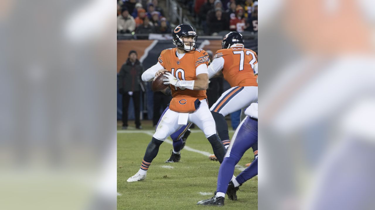 Chicago Bears center Cody Whitehair (65) and quarterback Justin Fields look  over the Tennessee Titans defense in an NFL preseason football game  Saturday, August 12, 2023, in Chicago. (AP Photo/Charles Rex Arbogast