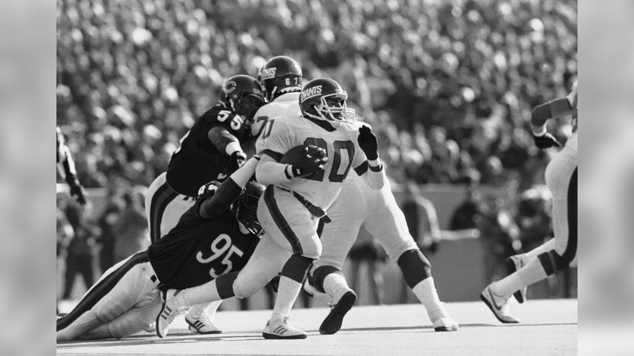 New York Giants quarterback Jeff Hostetler does a little scrambling to  avoid Chicago Bears Steve McMichael (rear) and Trace Armstrong (93) during  third quarter action in NFL playoff game, Sunday, Jan. 14