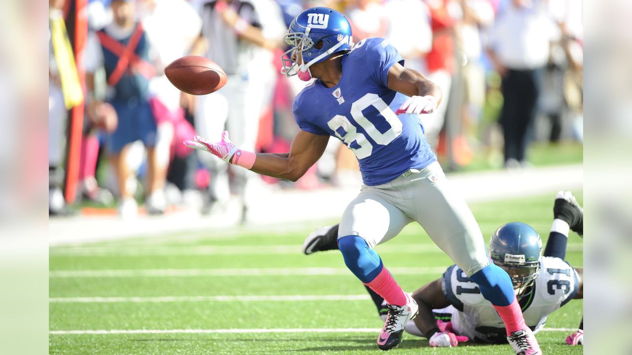 Seattle Seahawks Kam Chancellor and New York Giants Victor Cruz leap for a  pass from Eli Manning before Cruz makes a one handed catch for a 68 yard  touchdown in the fourth