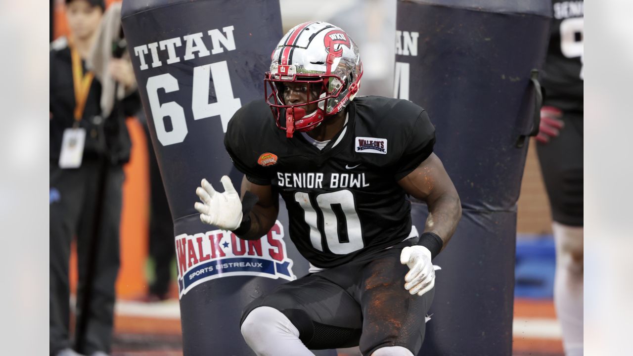 American Team defensive lineman DeAngelo Malone of Western Kentucky (10)  runs through drills during practice for