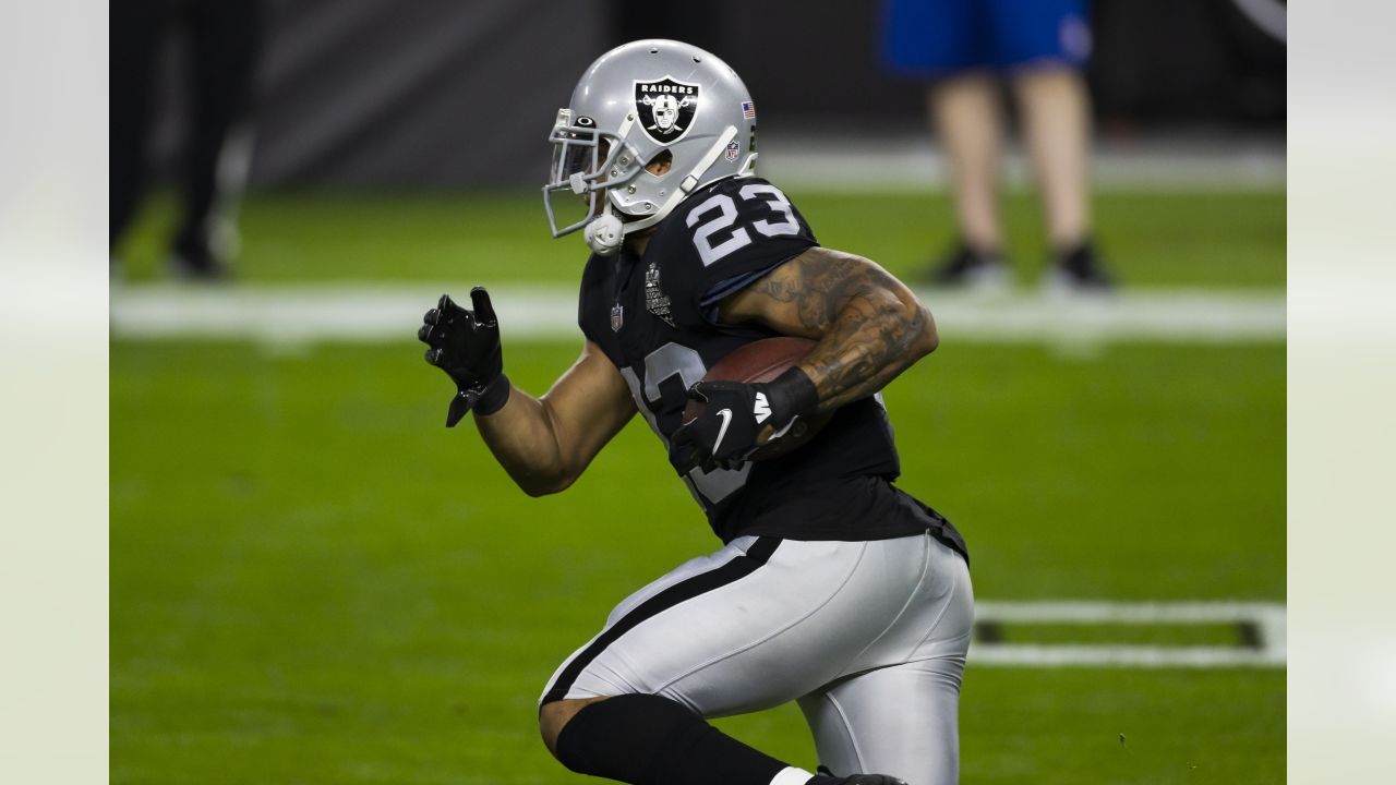 Raiders running back Devontae Booker (23) warms up before the start of an  NFL football game aga …