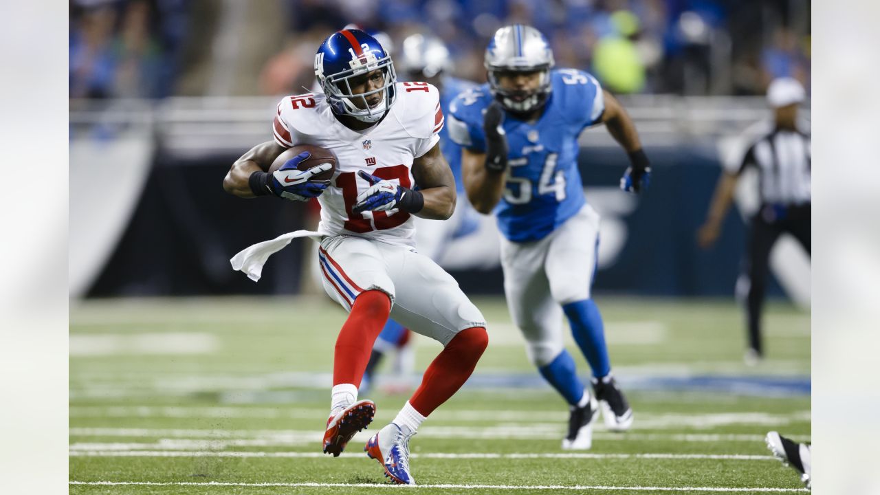 Detroit Lions wide receiver Amon-Ra St. Brown (14) runs the ball against  New York Giants cornerback Rodarius Williams (25) during the second half of  an NFL football game, Sunday, Nov. 20, 2022