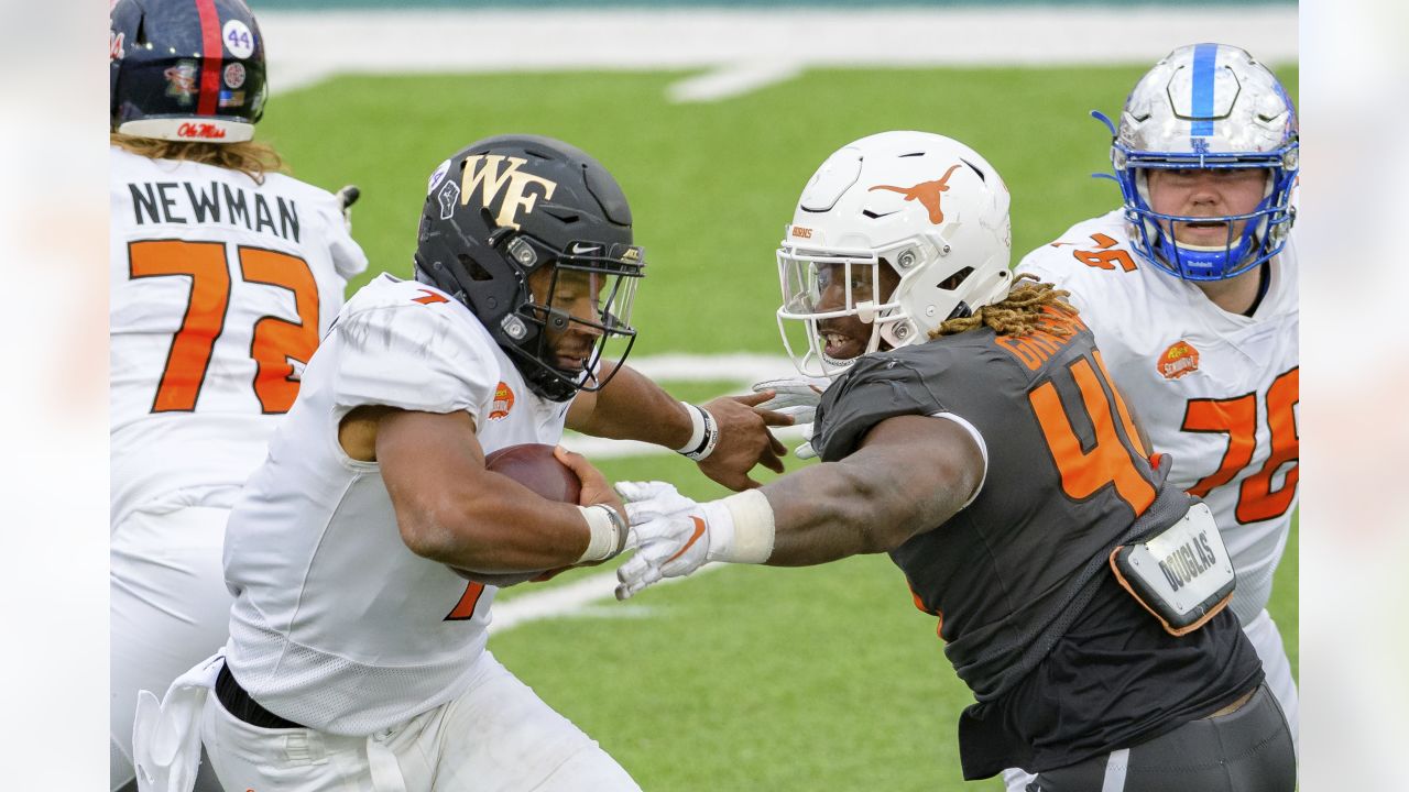 Wake Forest defensive lineman Carlos Basham Jr. talks to a coach during  American Team practice Wednesday, Jan. 27, 2021, in Mobile, Ala., for the  Senior Bowl college football game. (AP Photo/Rusty Costanza