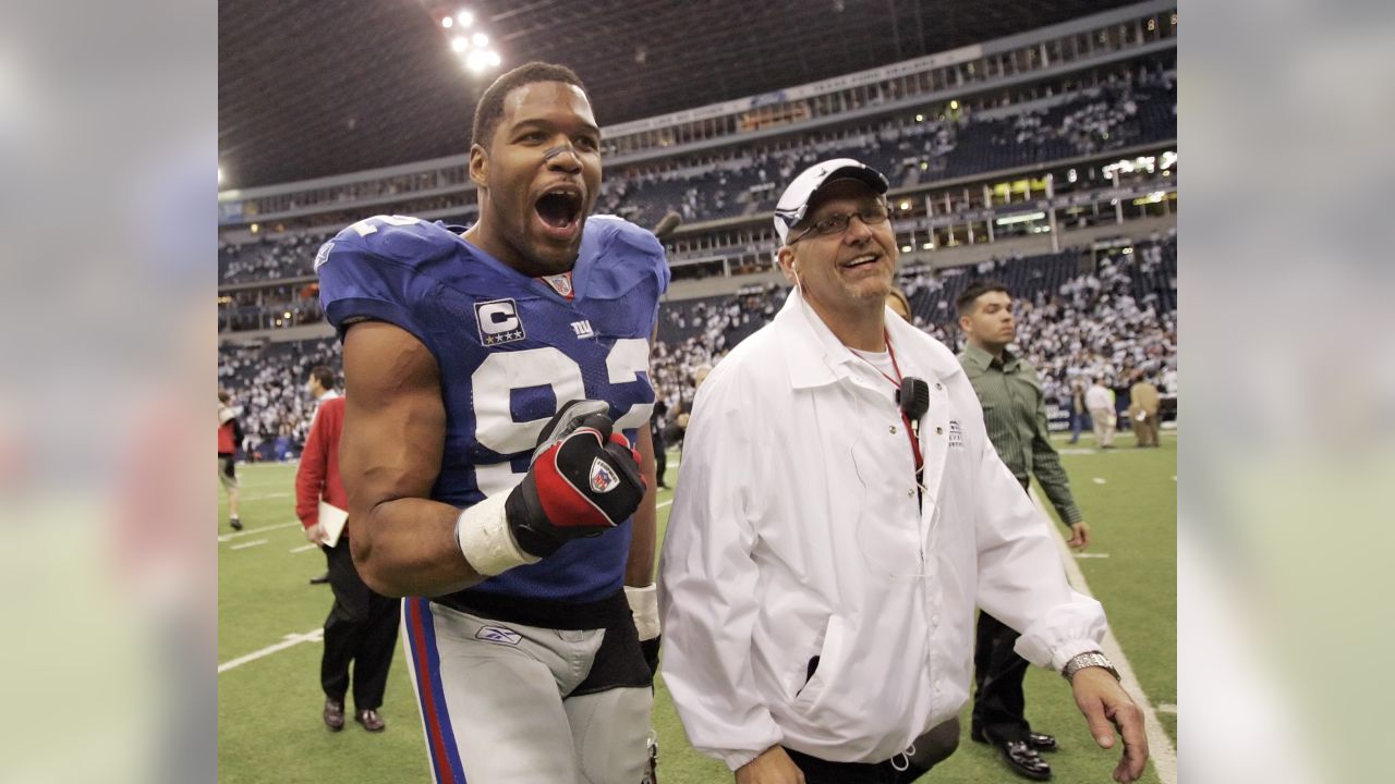 Dallas Cowboys Tony Romo gets pressured by New York Giants Michael Strahan  in the second half of their playoff game January 13, 2008 at Texas Stadium  in Irving, TX. The Giants beat