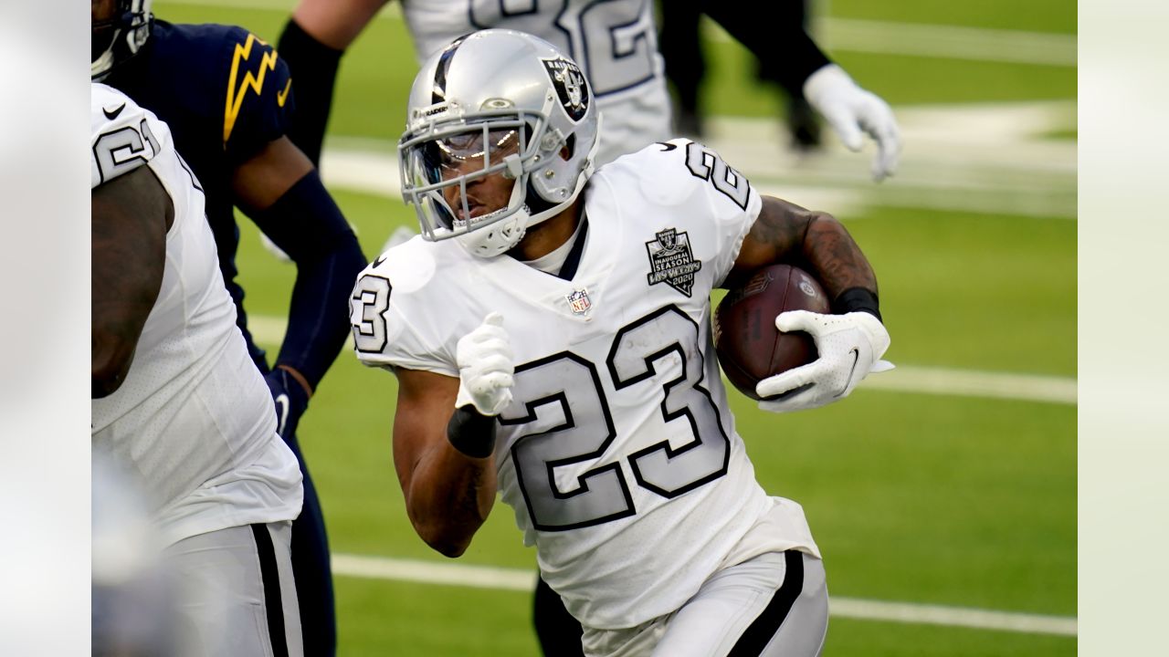 Raiders running back Devontae Booker (23) warms up before the start of an  NFL football game aga …