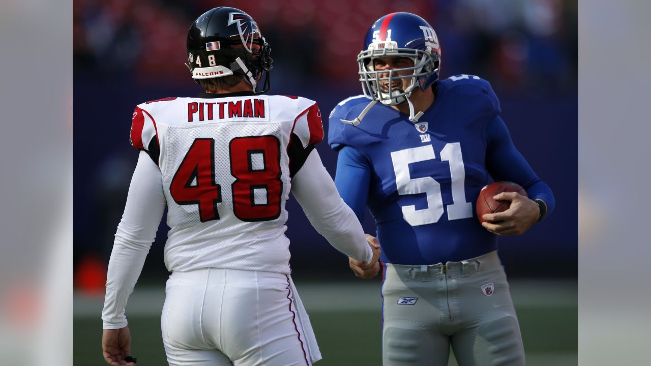 New York Giants line backer Zak DeOssie holds up a newspaper proclaiming  the Giants' win over the New England Patriots at Super Bowl XLII at  University of Phoenix Stadium in Glendale, Arizona