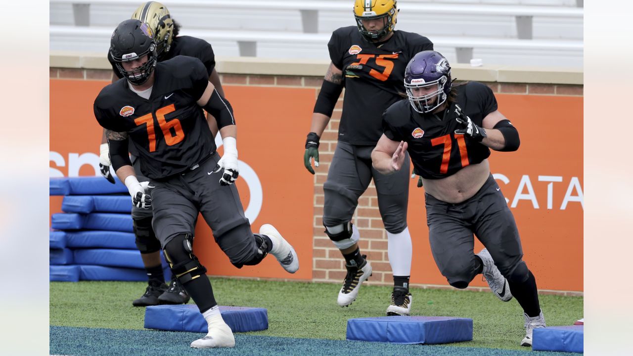 National Team defensive lineman Tarron Jackson of Coastal Carolina (99)  runs a blocking drill with offensive lineman Dillon Radunz of North Dakota  State(FCS) (75) during the National team practice for the NCAA