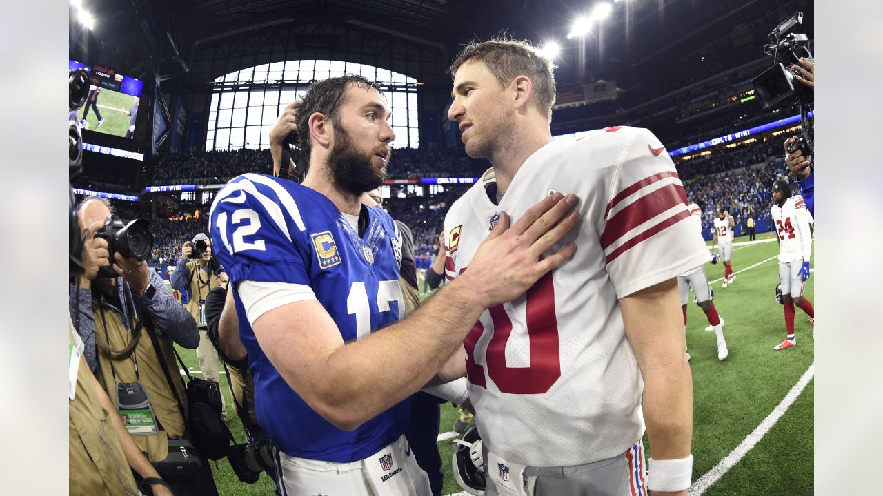 Indianapolis Colts quarterback Andrew Luck (12) and New York Giants  quarterback Eli Manning (10) meet following