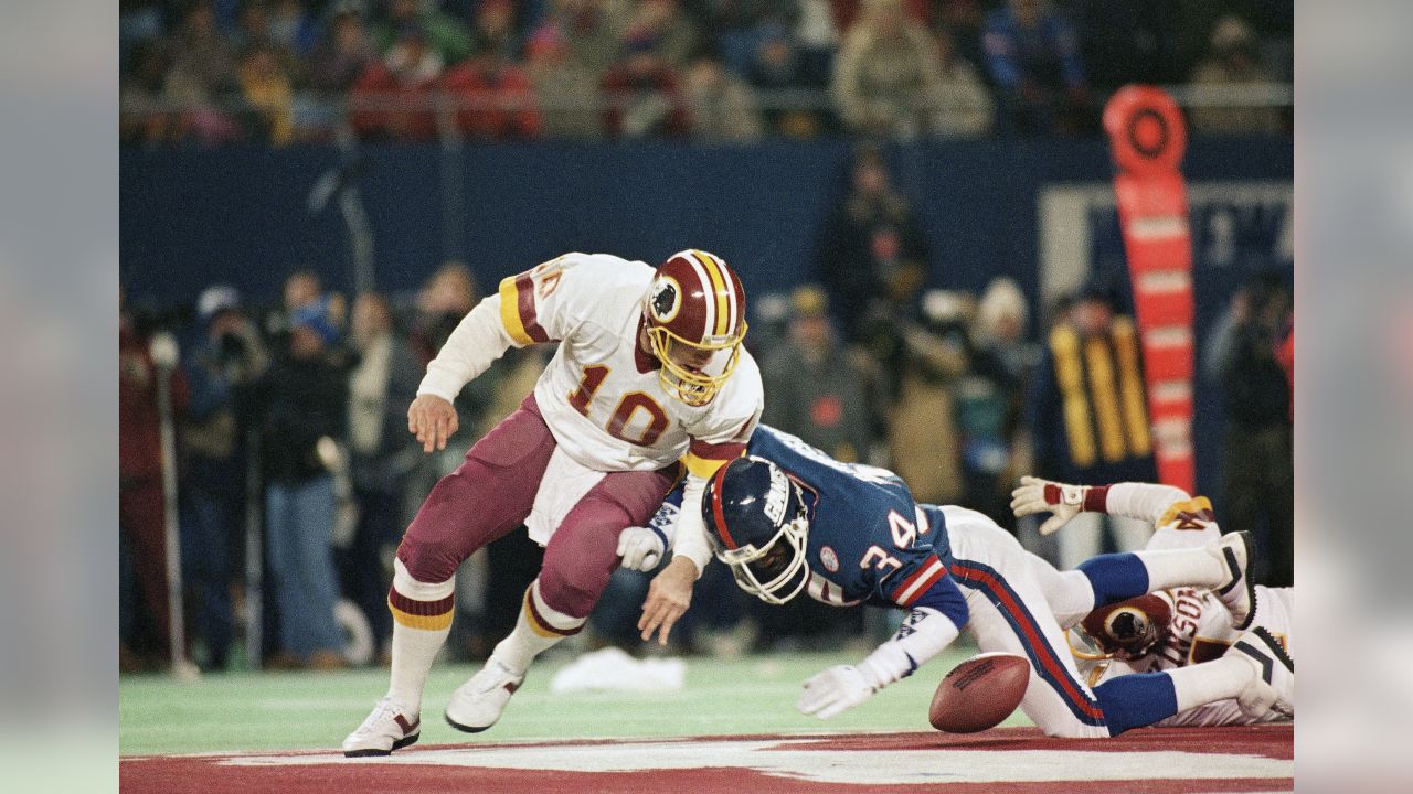 Washington Redskins wide receiver Art Monk (81) is stopped in his tracks by  New York Giants iinebacker Harry Carson (53) as he receives a Jay Schroeder  pass in the third quarter action