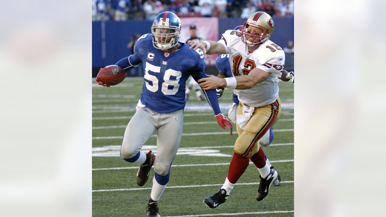 New York Giants Osi Umenyiora reacts next to Washington Redskins Fred Davis  (86) after Umenyiora forces and recovers a fumble and runs it back 37 yards  for a touchdown in the second