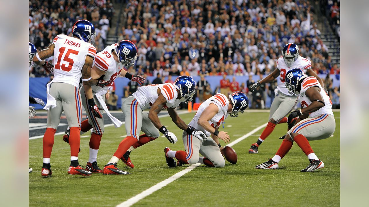 New York Giants line backer Zak DeOssie holds up a newspaper proclaiming  the Giants' win over the New England Patriots at Super Bowl XLII at  University of Phoenix Stadium in Glendale, Arizona