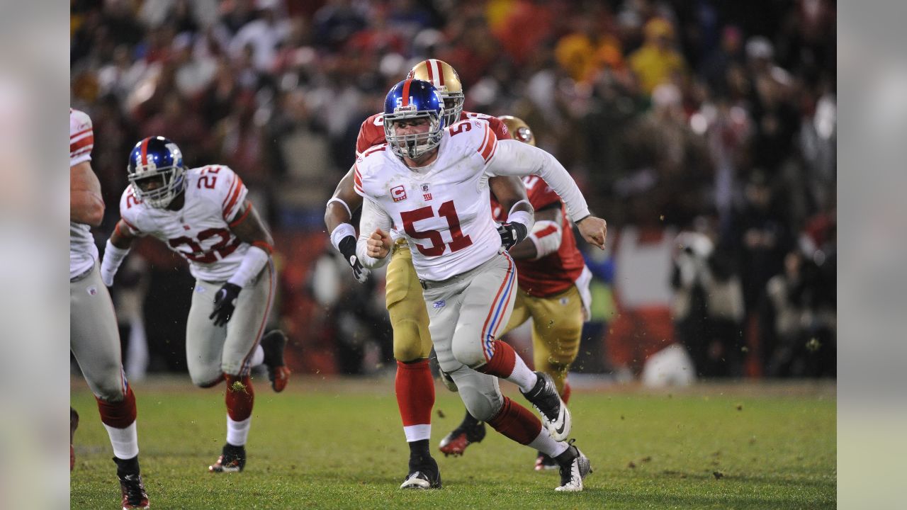 New York Giants line backer Zak DeOssie holds up a newspaper proclaiming  the Giants' win over the New England Patriots at Super Bowl XLII at  University of Phoenix Stadium in Glendale, Arizona