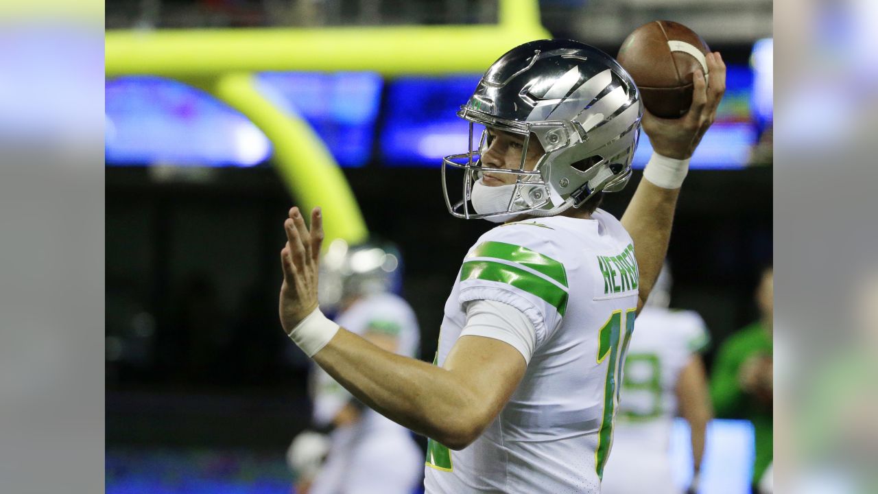 Justin Herbert Oregon Ducks Unsigned White Jersey Warming Up Photograph