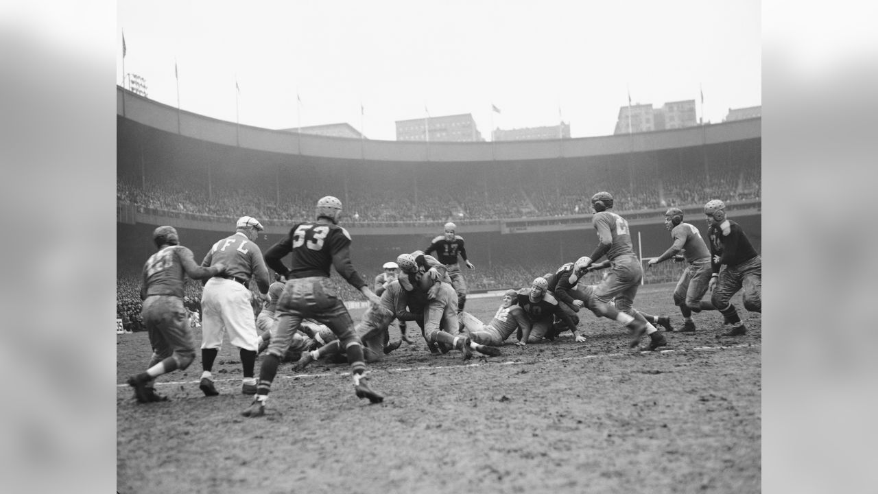 Only two feet short of a touchdown, Green Bay Packers Clarke Hinkle is  shown as he was halted by the New York Giants in the second period of their  championship game with