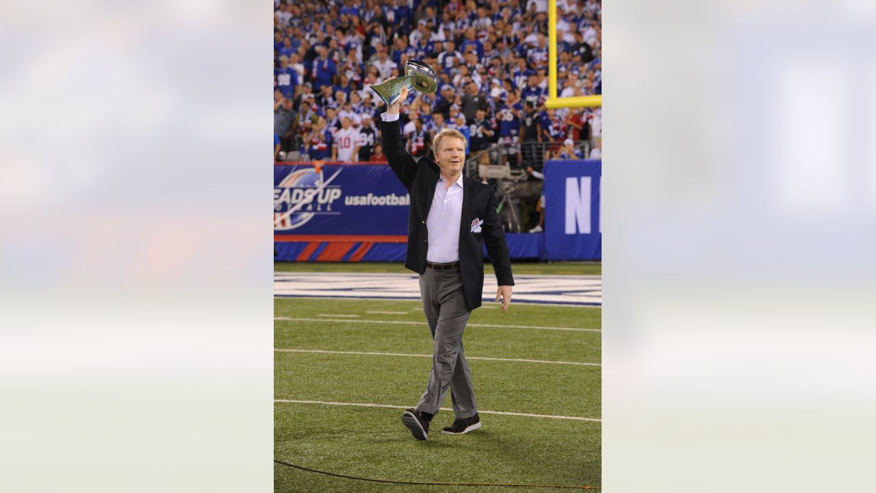 Former New York Giants Phil Simms waves to fans as he is inducted into the Giants  Ring of Honor at New Meadowlands Stadium in East Rutherford, New Jersey,  Sunday, October 3, 2010. (