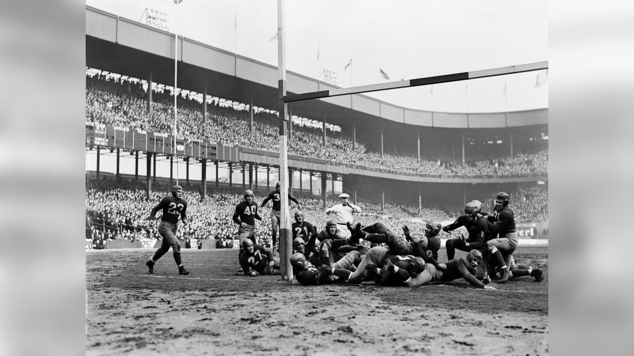 Sammy Baugh (33) at the extreme left throws a forward pass to teammate  Riley Smith (35) at the right on Dec. 5, 1937 in New York. Cliff Battles  (20) Redskins back, is