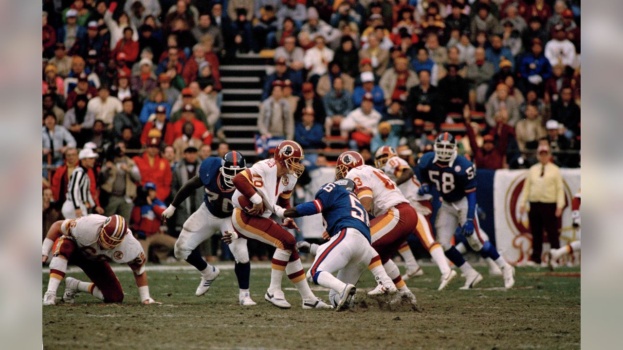The ball pops free as Washington Redskins quarterback Jay Schroeder is hit  by Giants Leonard Marshall while trying to pass during the third quarter of NFC  Championship game in East Rutherford, N.J.