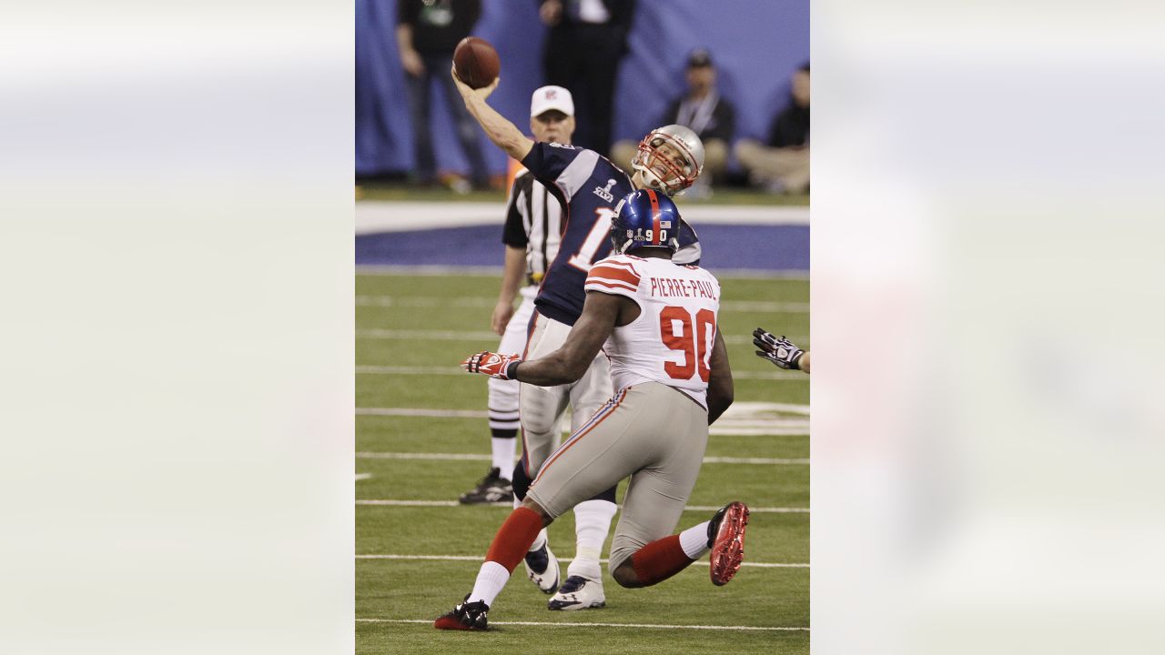 New York Giants defensive end jason Pierre-Paul stands over a fallen New  England Patriots quarterback Tom Brady during the fourth quarter at Super  Bowl XLVI at Lucas Oil Stadium on February 5