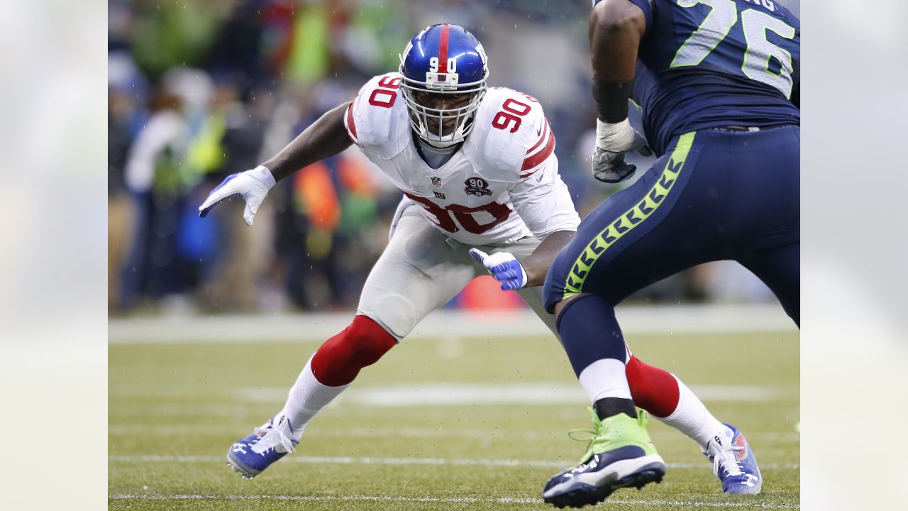 New York Giants defensive end jason Pierre-Paul stands over a fallen New  England Patriots quarterback Tom Brady during the fourth quarter at Super  Bowl XLVI at Lucas Oil Stadium on February 5