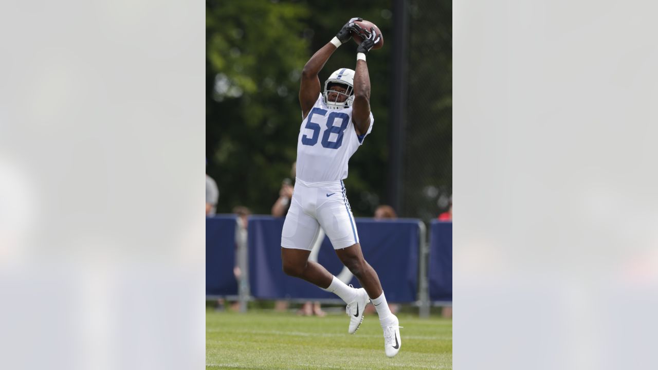 Two Indianapolis Colts fan measures themselves against Indianapolis Colts  linebacker Darius Leonard in Indianapolis Colts City at the NFL team's  football training camp in Westfield, Ind., Saturday, July 31, 2021. (AP  Photo/Michael