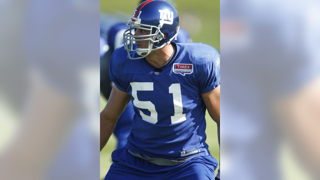 New York Giants line backer Zak DeOssie holds up a newspaper proclaiming  the Giants' win over the New England Patriots at Super Bowl XLII at  University of Phoenix Stadium in Glendale, Arizona