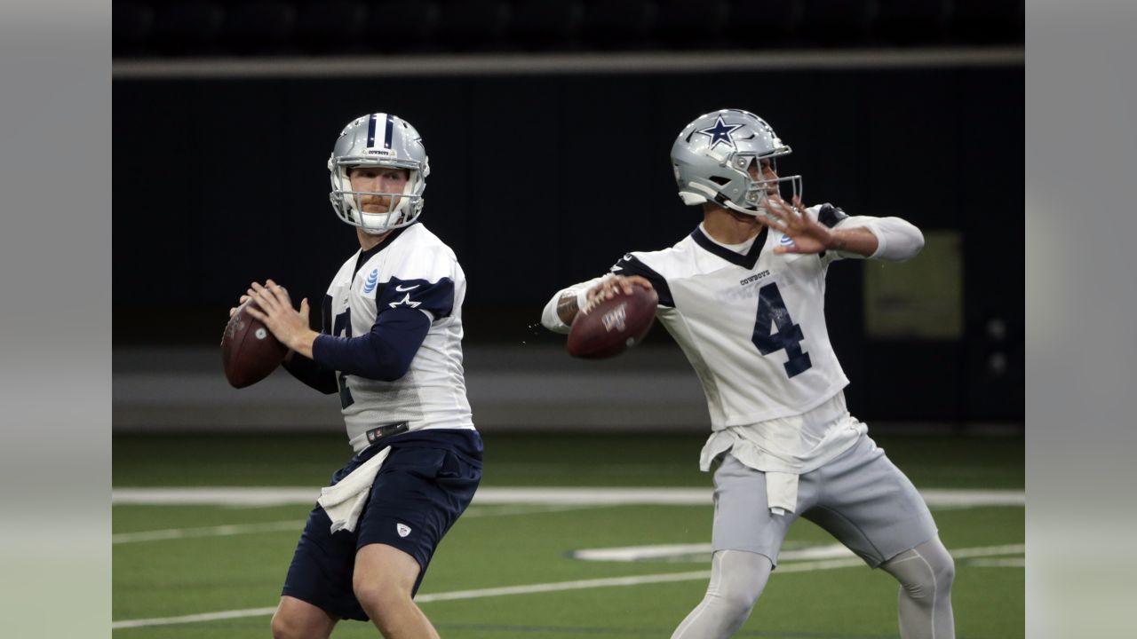 Dallas Cowboys quarterback Cooper Rush throws a pass in a drill