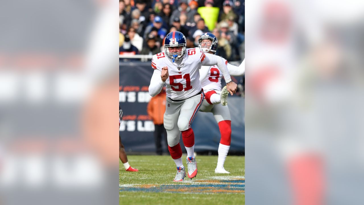 New York Giants line backer Zak DeOssie holds up a newspaper proclaiming  the Giants' win over the New England Patriots at Super Bowl XLII at  University of Phoenix Stadium in Glendale, Arizona