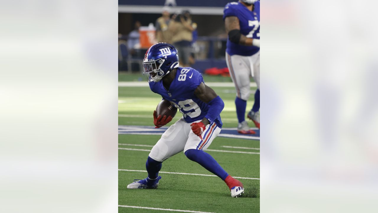 Dallas Cowboys wide receiver Cedrick Wilson (11) gains first down yardage  after catching a pass in the first half of an NFL football game against the  New York Giants in Arlington, Texas