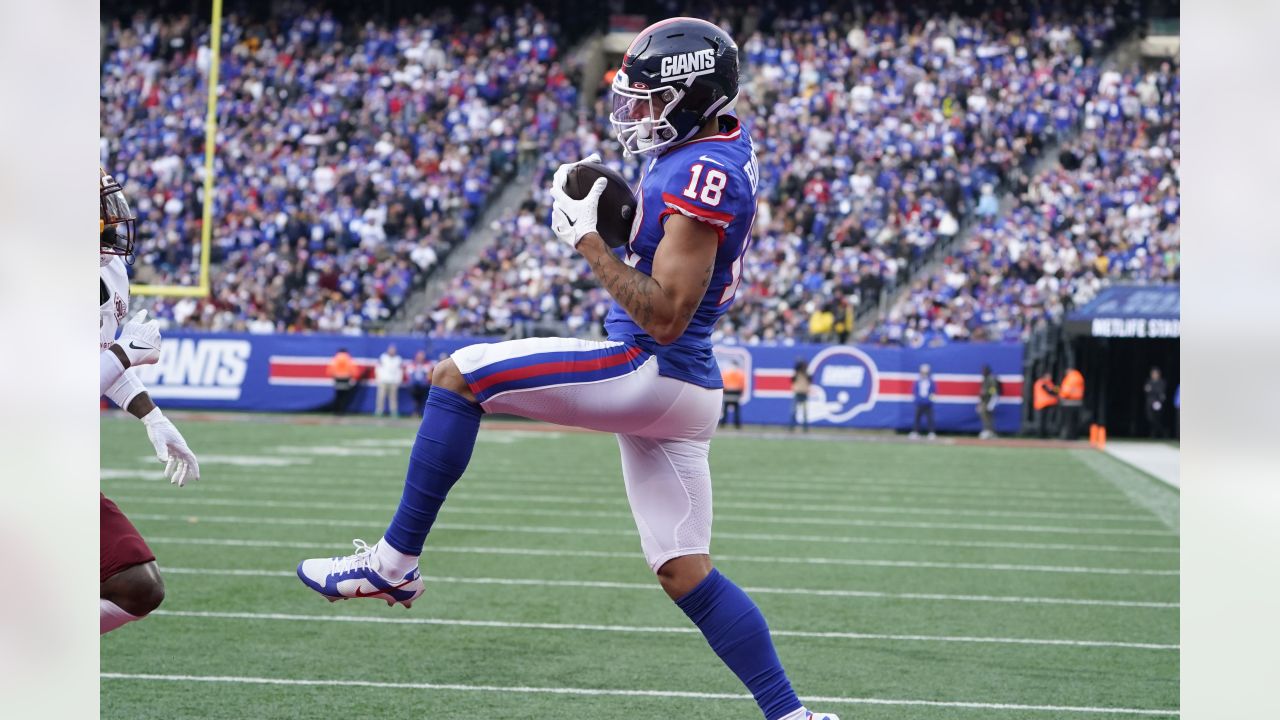 New York Giants wide receiver Isaiah Hodgins (18) runs with the ball  against the Washington Commanders during an NFL football game Sunday, Dec.  4, 2022, in East Rutherford, N.J. (AP Photo/Adam Hunger