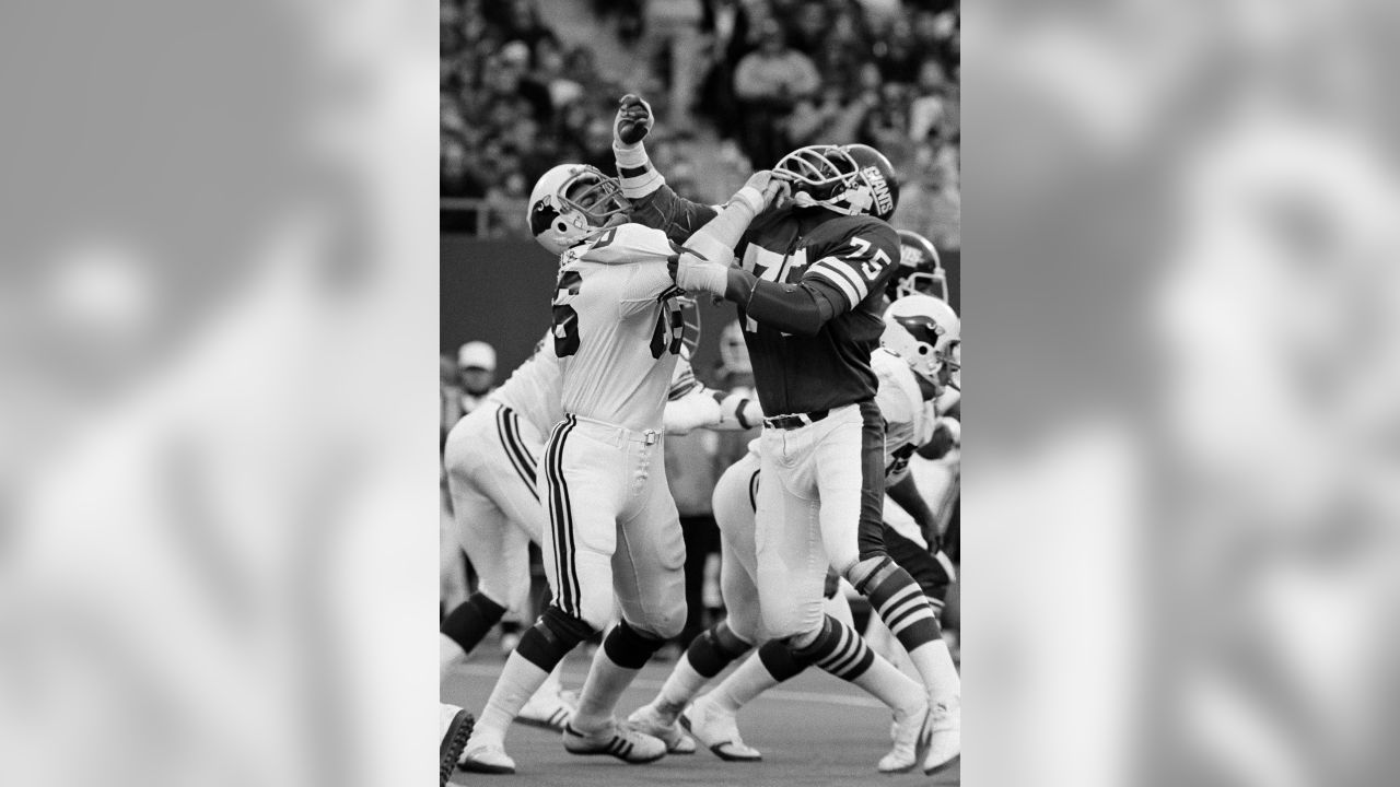 New York Giant quarterback Jeff Hostetler threads his way through Phoenix  Cardinals defenders on his way to a 19 yard touchdown during the first  quarter of their game in Tempe, Arizona Sunday