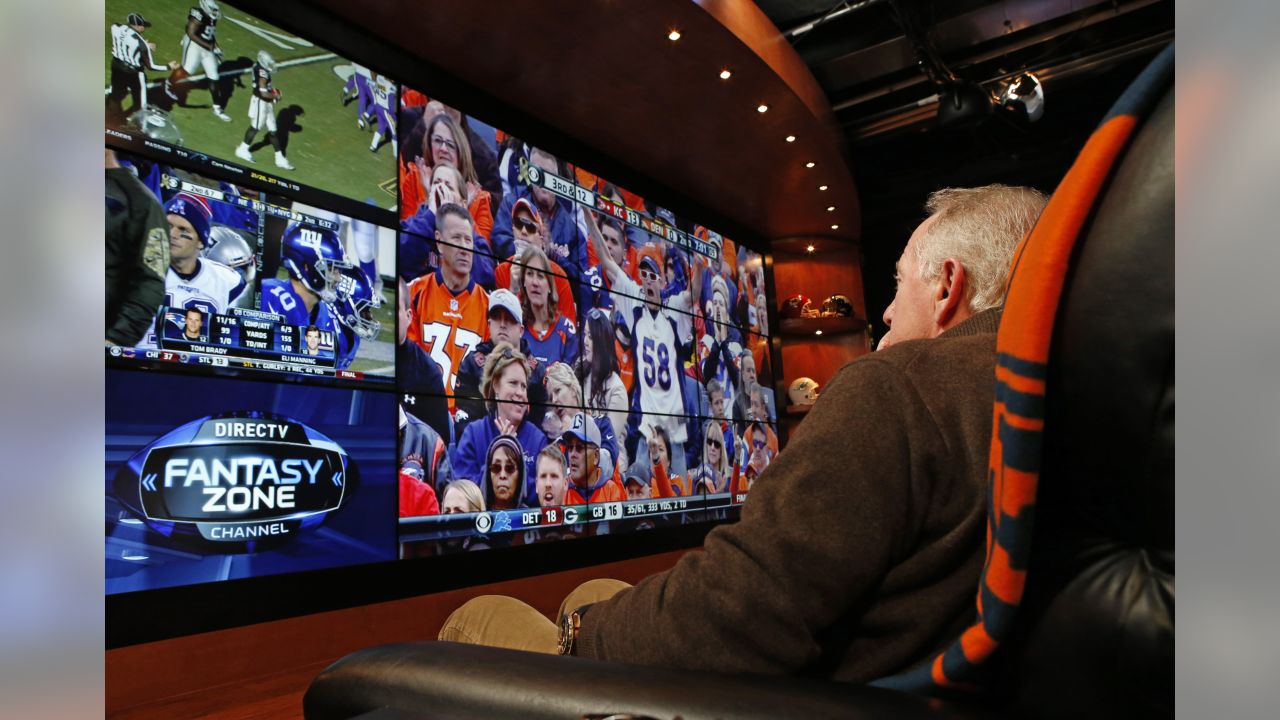 Archie Manning, right, watches his son., Denver Broncos