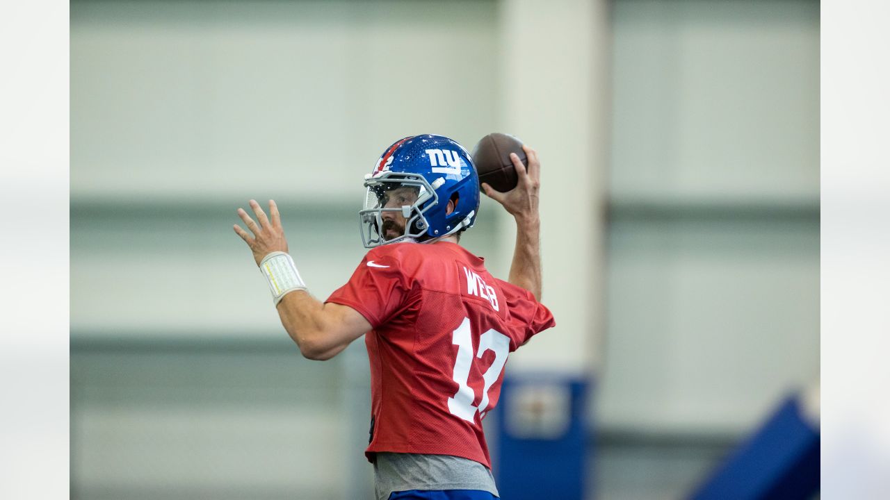 New York Giants quarterback Davis Webb (12) drops back to make a pass  during the second half of an NFL football game against the New England  Patriots, Thursday, Aug. 11, 2022, in