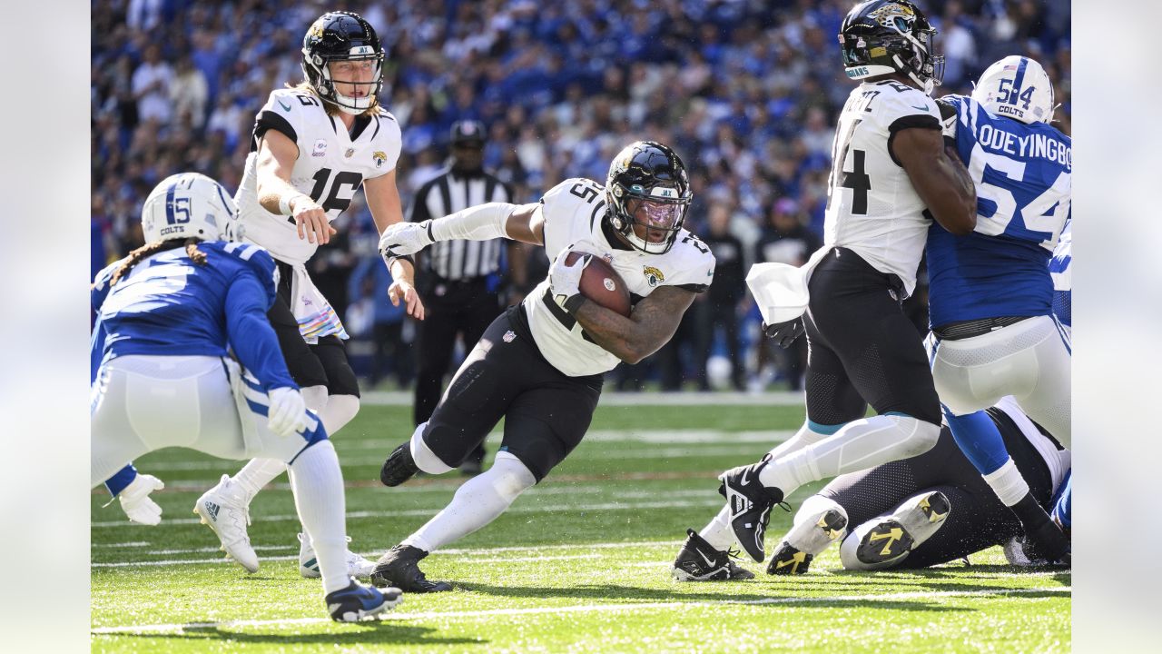 Jacksonville Jaguars running back James Robinson (30) slips past  Indianapolis Colts free safety …