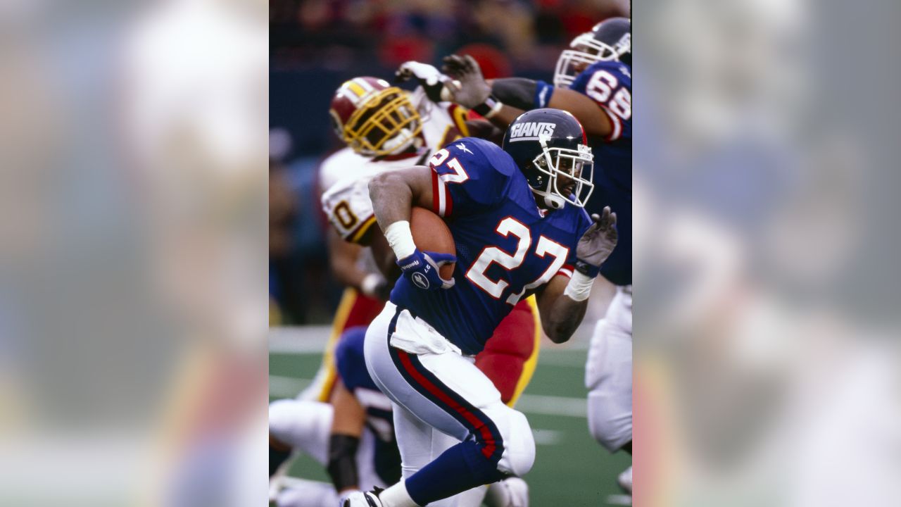 New York Giants Michael Strahan points his finger in the air and winks  while walking off of the field in week 13 at Giants Stadium in East  Rutherford, New Jersey on December