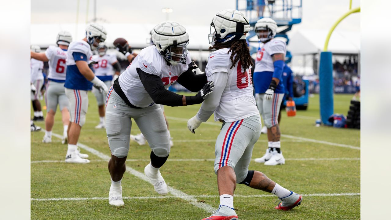 New York Giants tackle Evan Neal #73 walks off the field after their 31-27  loss to the New York Jets in an NFL pre-season football game, Sunday, Aug.  27, 2022, in East