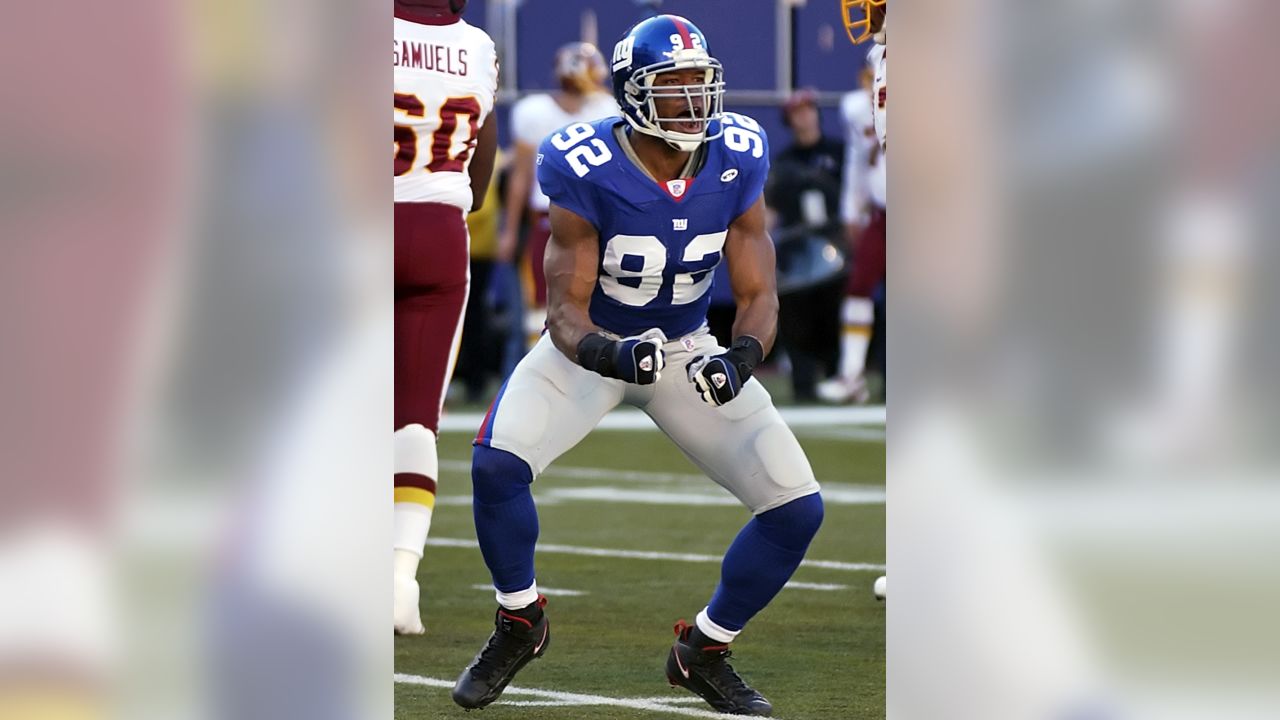 New York Giants Michael Johnson (20) holds up Washington Redskins Clinton  Portis (26) in the first quarter at Giants Stadium in East Rutherford, New  Jersey on September 4, 2008. The Giants defeated