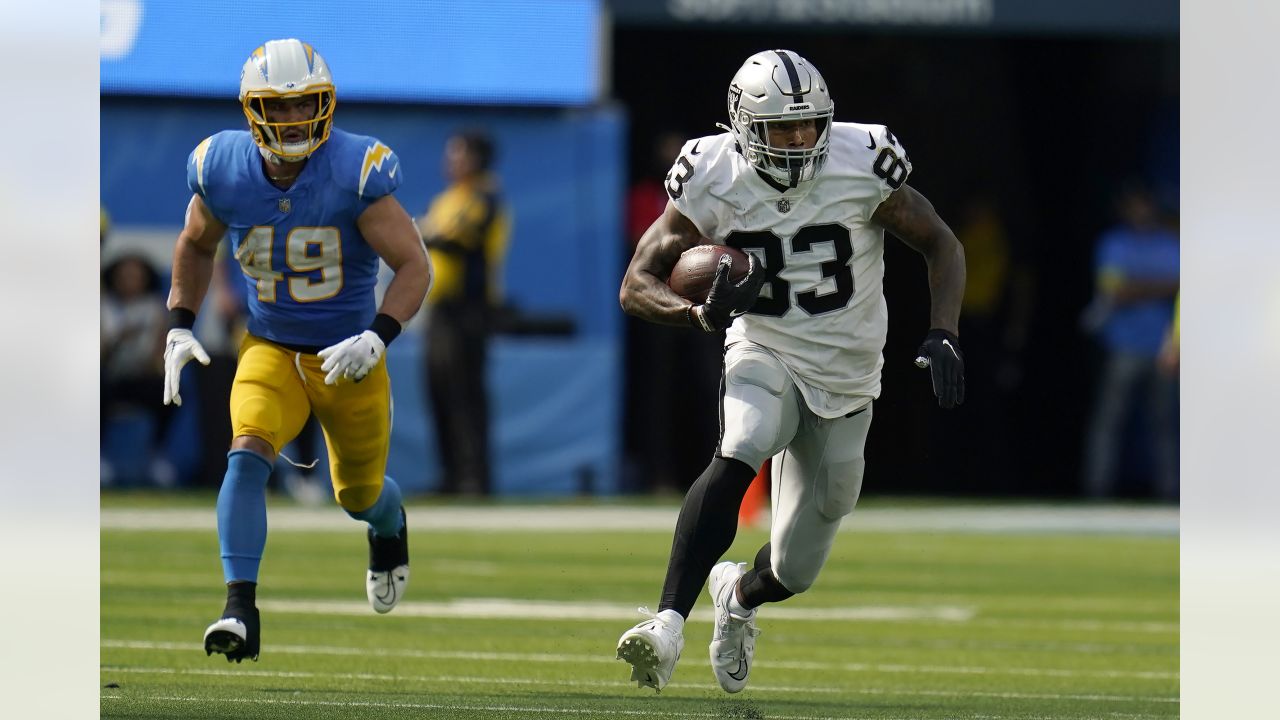 Las Vegas Raiders running back Josh Jacobs (28) carries against Los Angeles  Chargers linebacker Drue Tranquill (49) during the first half of an NFL  football game, Sunday, Dec. 4, 2022, in Las