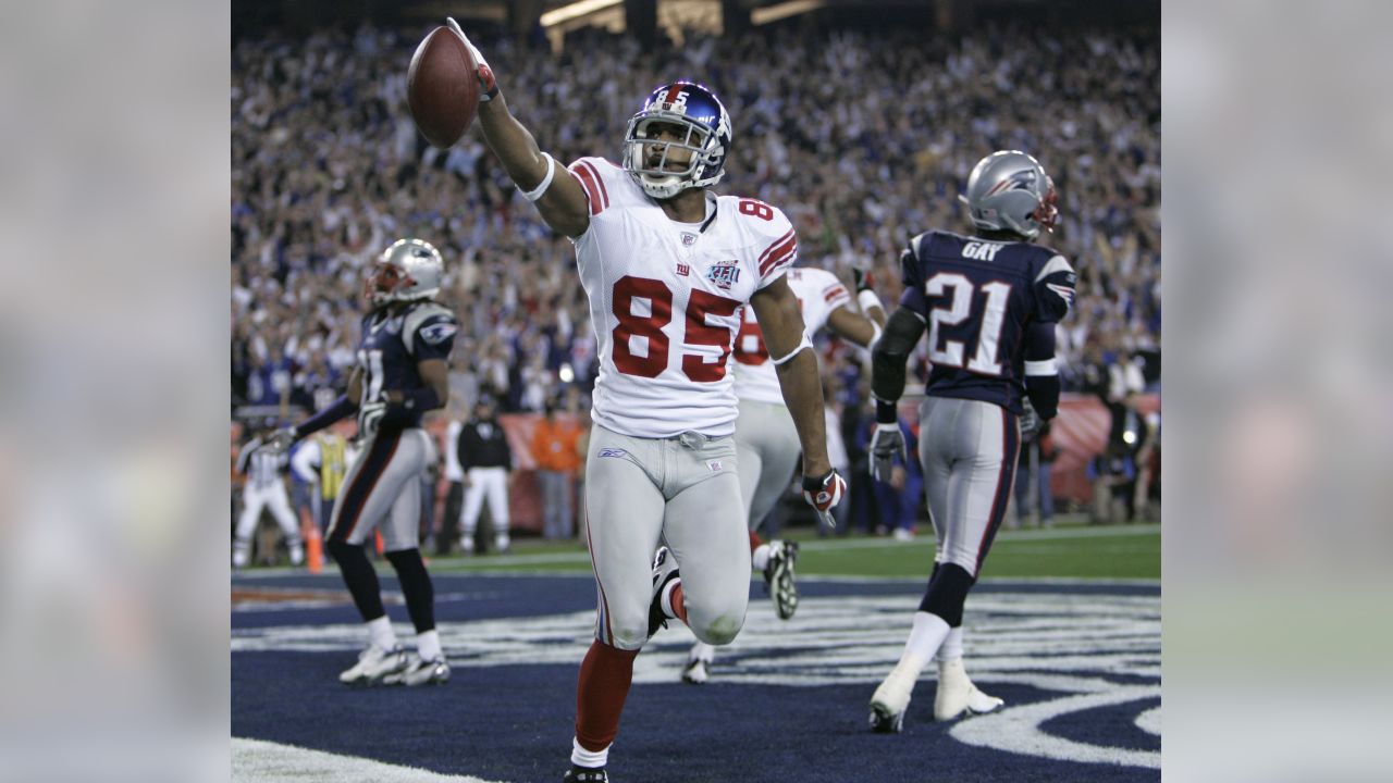 New York Giants receiver David Tyree (85) hauls in a long pass against the New  England Patriots' Rodney Harrison (37) on the game-winning drive in a 17-14  victory over the New England