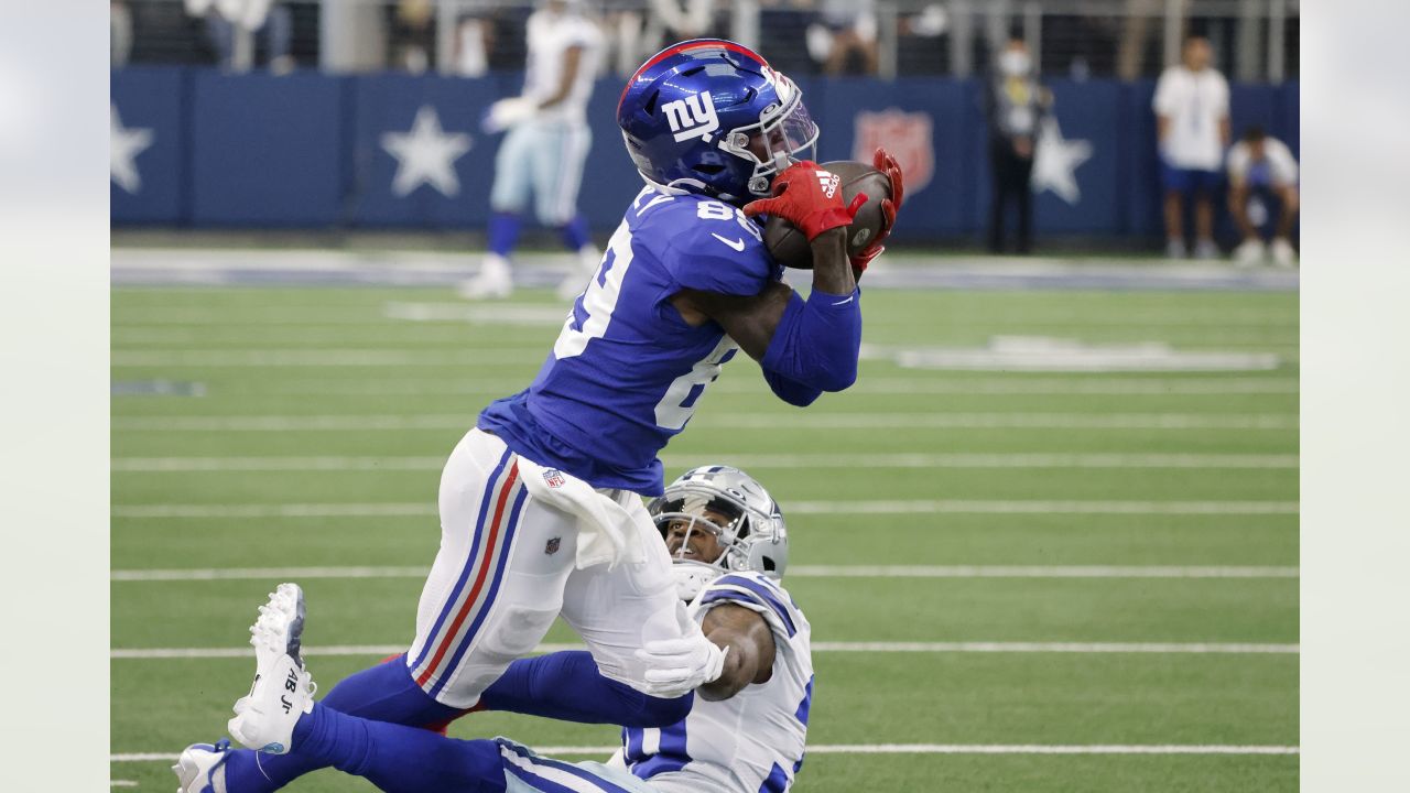 Dallas Cowboys wide receiver Cedrick Wilson (11) gains first down yardage  after catching a pass in the first half of an NFL football game against the  New York Giants in Arlington, Texas