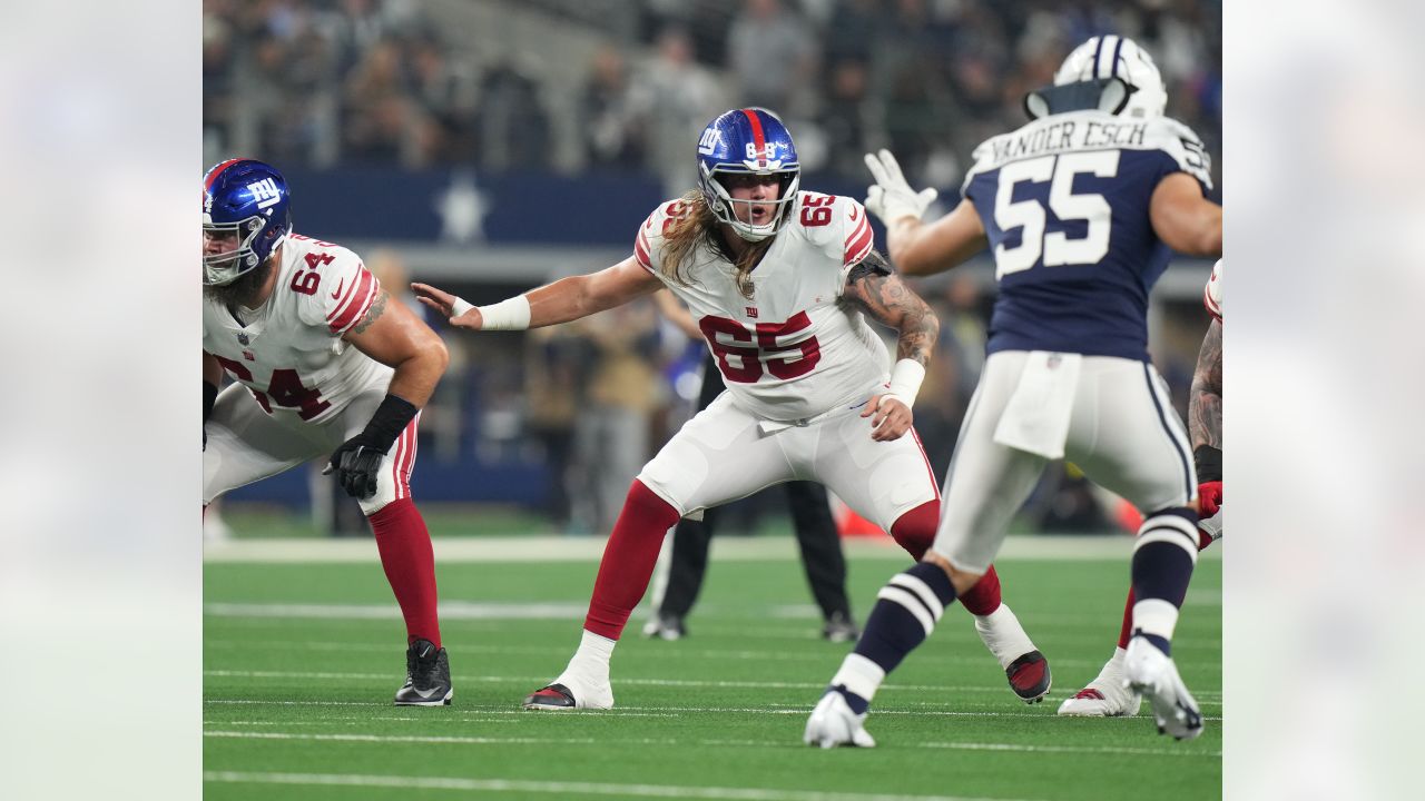 New York Giants center Nick Gates (65) lays on the field as members of the  team medical staff tend to him during the first half of an NFL football  game against the