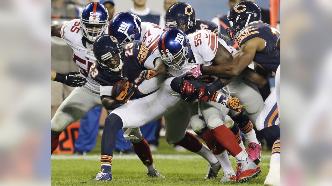 Wide receiver Don Hermann (85) of the New York Giants is pulled down by  linebacker Lee Roy Caffey (60) of the Chicago Bears in first quarter action  in New York, Sept. 19