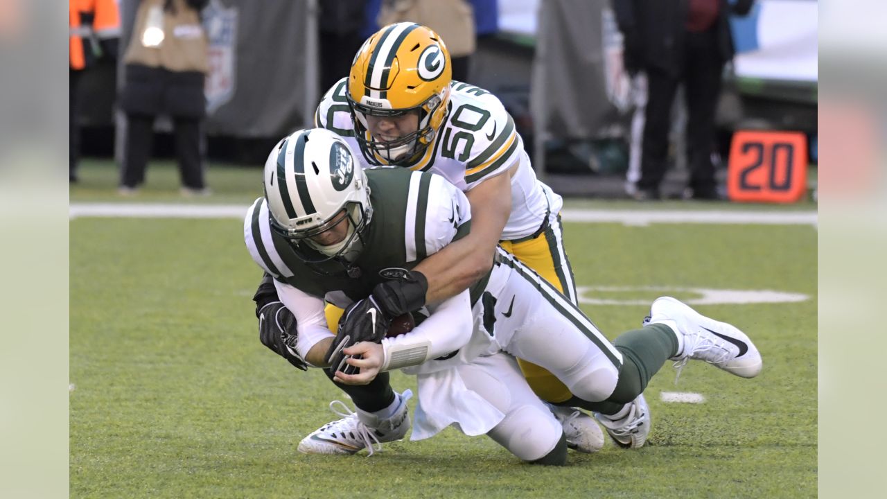 GREEN BAY, WI - OCTOBER 16: New York Jets defensive end Jacob Martin (54)  chases down Green Bay Packers quarterback Aaron Rodgers (12) during a game  between the Green Bay Packers and