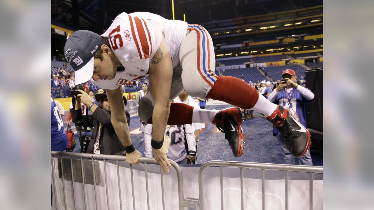 New York Giants line backer Zak DeOssie holds up a newspaper proclaiming  the Giants' win over the New England Patriots at Super Bowl XLII at  University of Phoenix Stadium in Glendale, Arizona