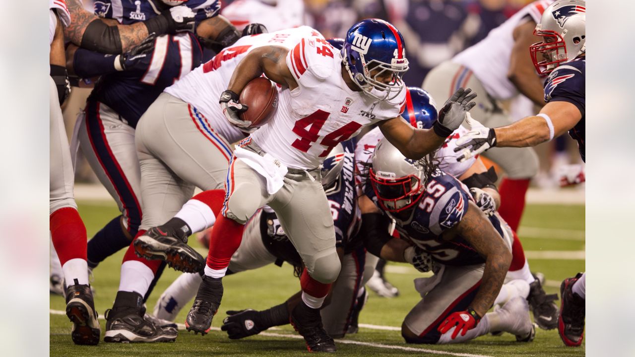 Defensive back Derrick Martin (22) of the New York Giants celebrates with  kids on the field at the end of Superbowl XLVI at Lucas Oil Stadium in  Indianapolis, Indiana on February 05