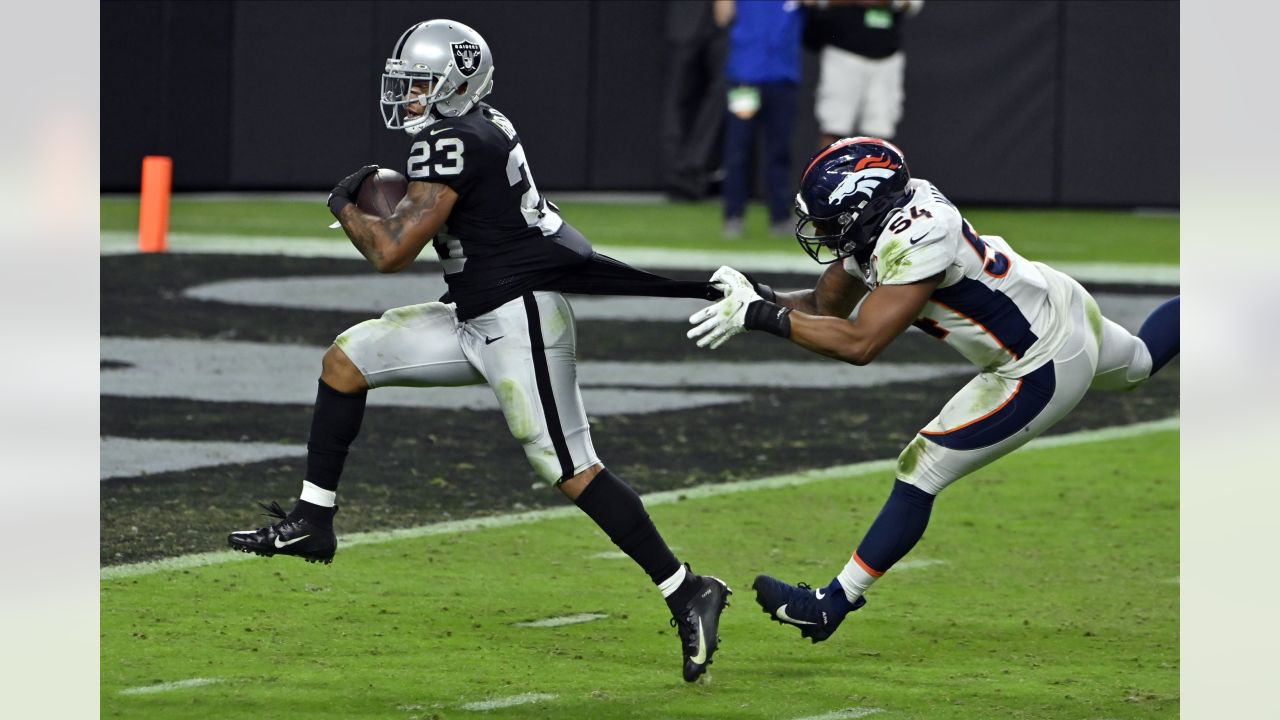 Raiders running back Devontae Booker (23) warms up before the start of an  NFL football game aga …