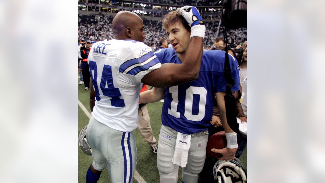 Dallas Cowboys Terrell Owens is pushed by New York Giants Corey Webster  (23) after catching a 12 yard touchdown pass in the fourth quarter at  Giants Stadium in East Rutherford, New Jersey